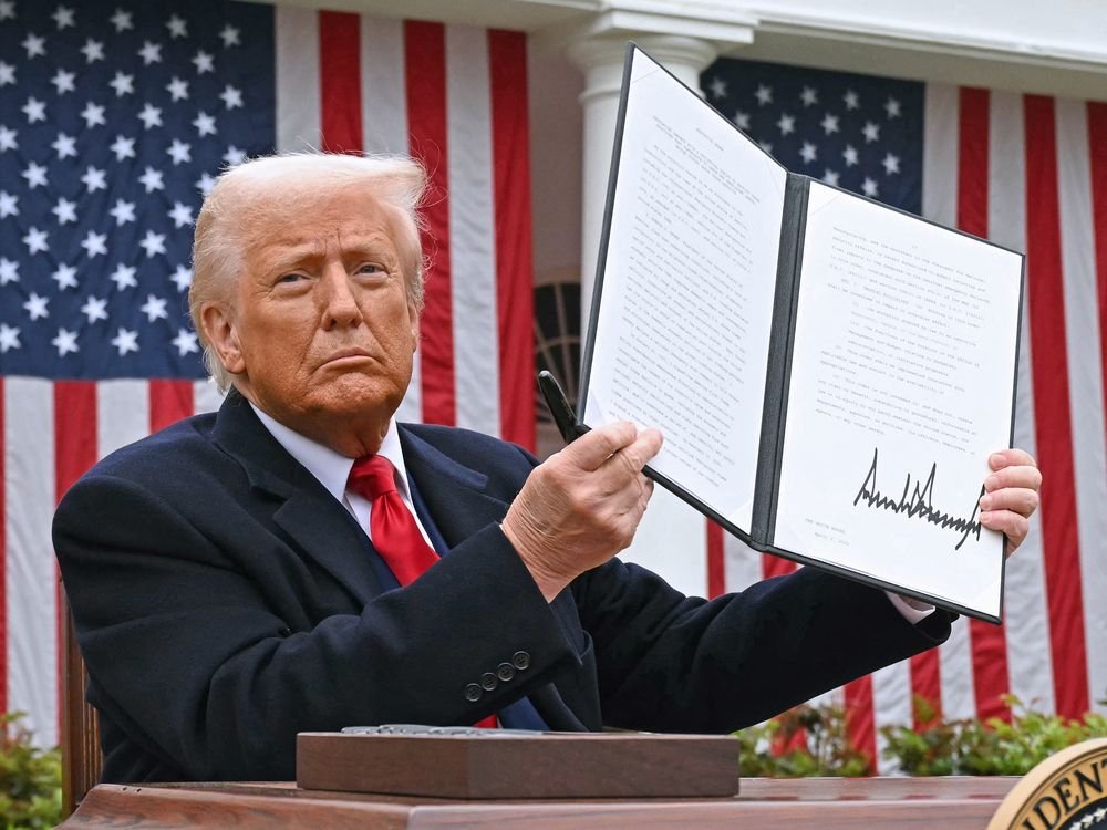 U.S. President Donald Trump holds a signed executive order after delivering remarks on reciprocal tariffs during an event in the Rose Garden at the White House in Washington, D.C., on April 2, 2025. 