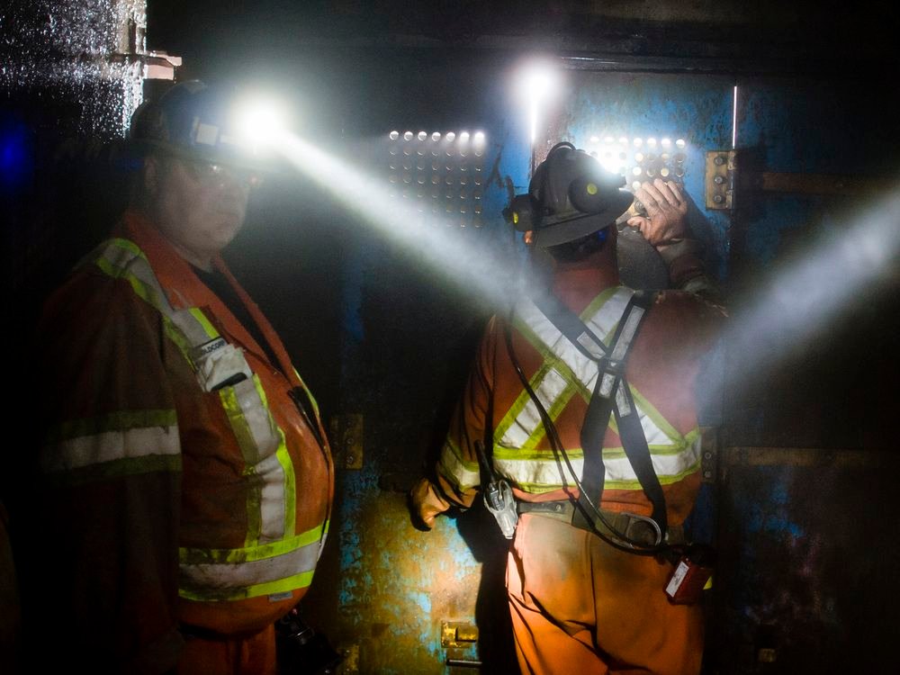 A group of gold miners make their way up the mine shaft on a elevator at Porcupine Gold Mines  in Timmins, Ontario.